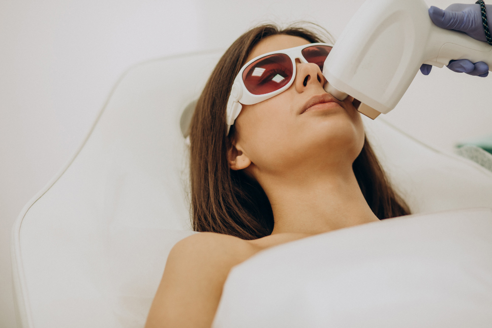 A woman in sunglasses undergoing laser hair removal treatment at Daydreams Med Spa, focusing on facial hair removal