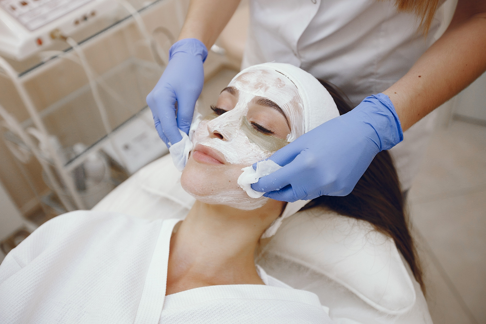 A woman receiving a skin fairness facial treatment at a beauty salon in Omaha and La Vista