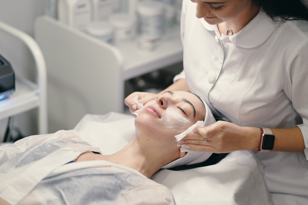 A woman undergoing a facial treatment in a beauty salon, representing the best facial Omaha for skincare enthusiasts.